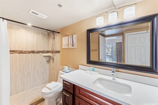 a bathroom with a sink toilet and shower