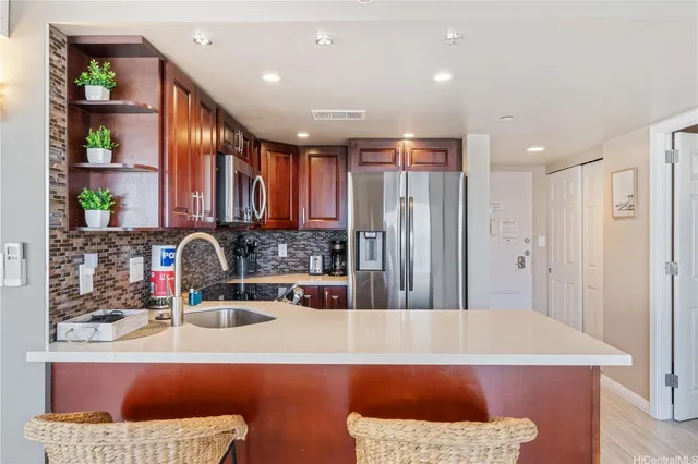 a kitchen with stainless steel appliances granite countertop a refrigerator and a sink
