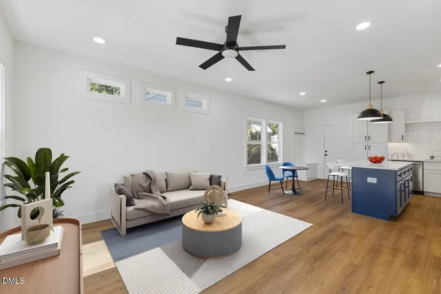 a living room with furniture and a wooden floor
