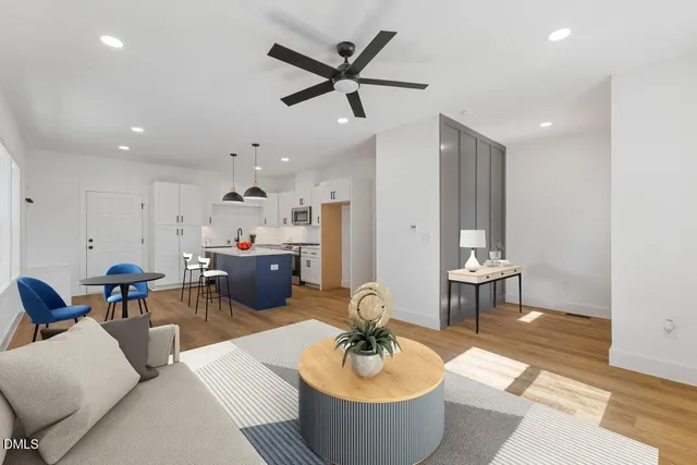 a living room with furniture a window and a chandelier