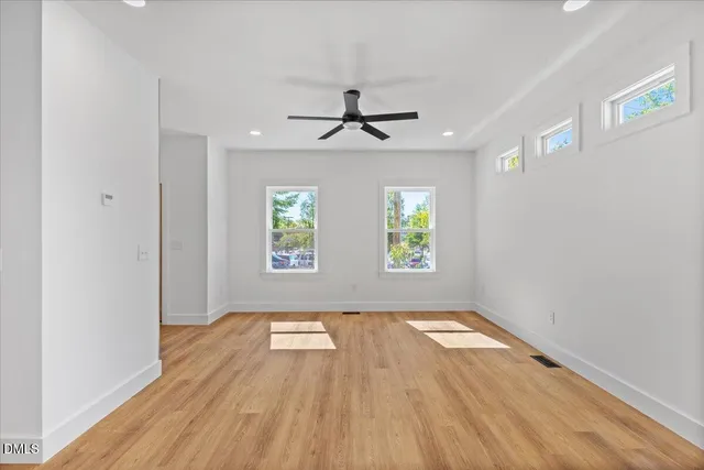 wooden floor in an empty room with a window