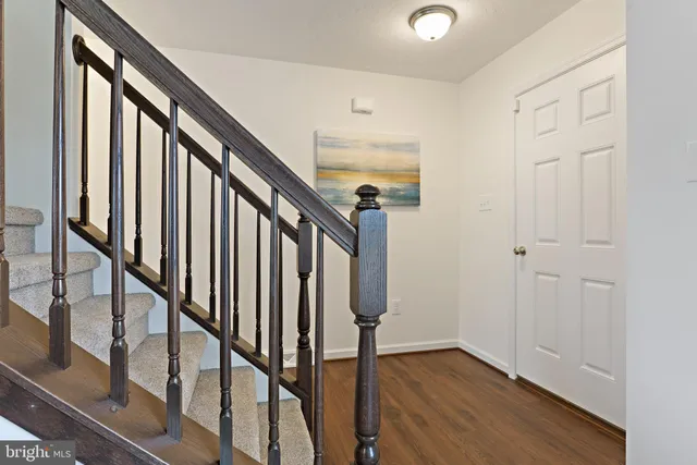 a view of entryway with wooden floor and stairs
