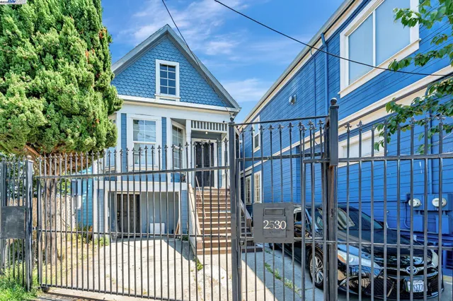 a view of a house with wooden fence