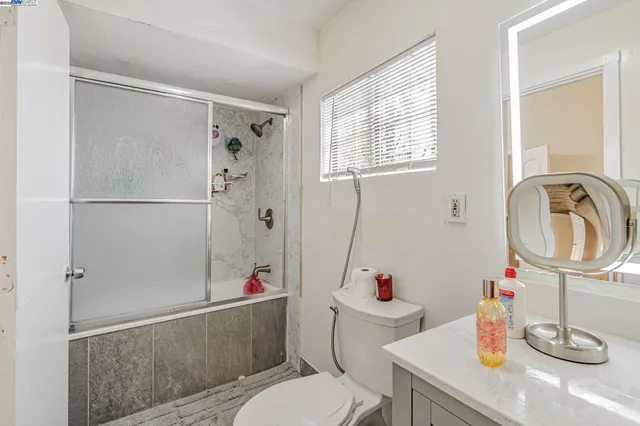 a bathroom with a sink a toilet and a shower