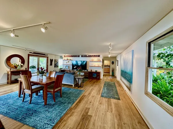 a dining room with furniture and wooden floor