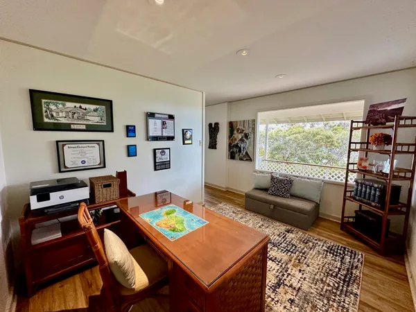 a living room with furniture and a bookshelf