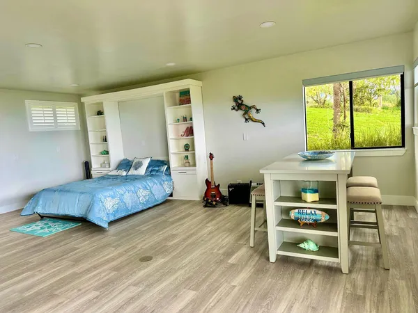 a bedroom with a bed and a chair