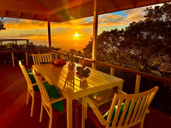 a view of a balcony dining table and chairs with wooden floor