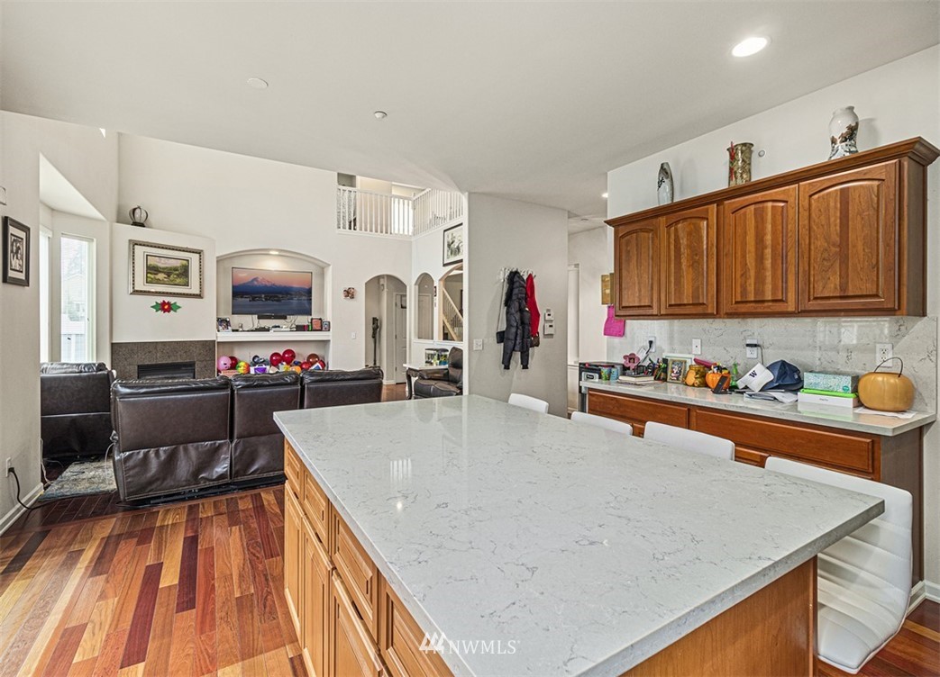 910 South 48th Street Renton, WA 98055 - Photo 11 of 30 a large kitchen with stainless steel appliances a stove a sink dishwasher and cabinets with wooden floor