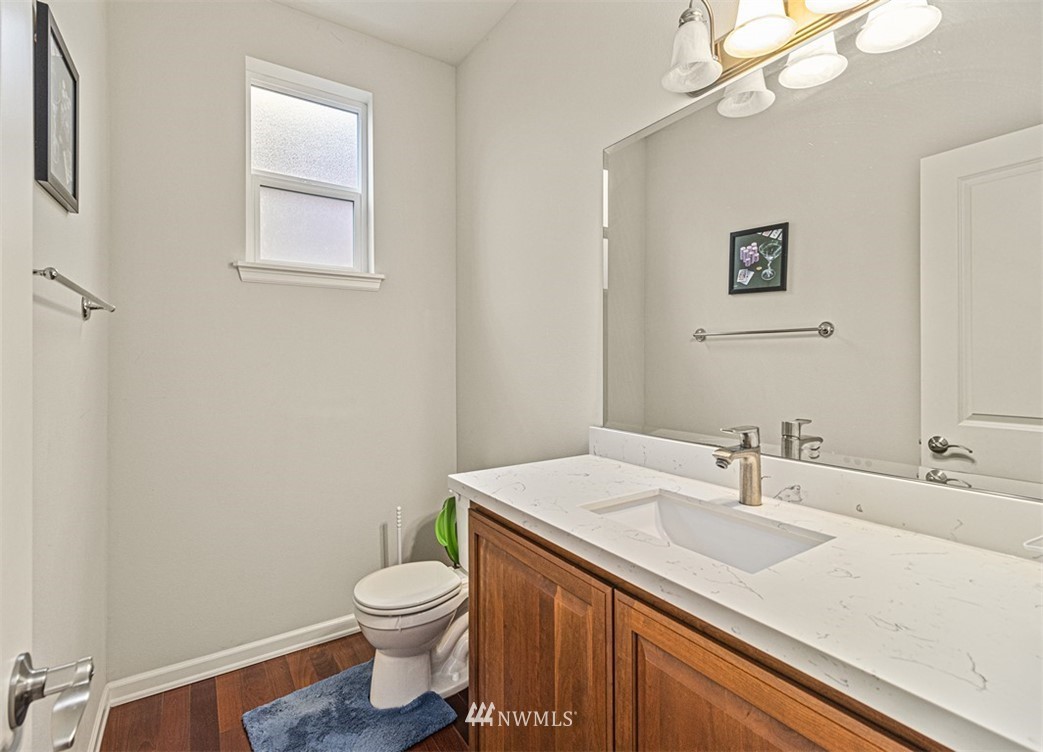 910 South 48th Street Renton, WA 98055 - Photo 13 of 30 a bathroom with a granite countertop sink a toilet and a mirror