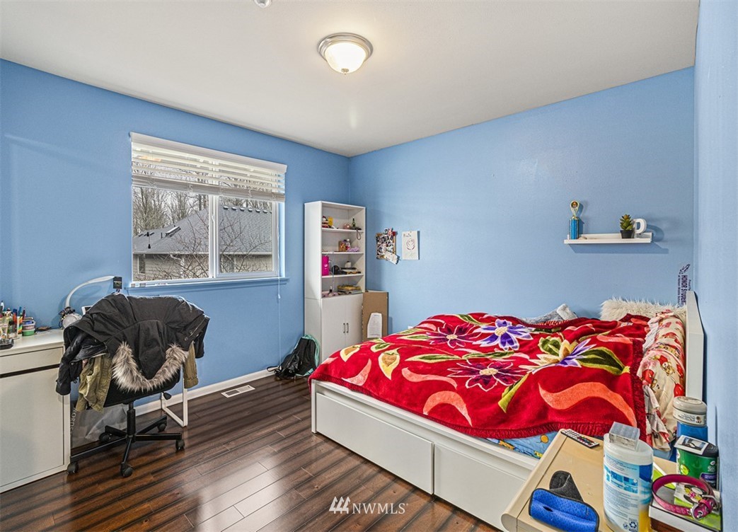910 South 48th Street Renton, WA 98055 - Photo 17 of 30 a bedroom with a bed and a chair