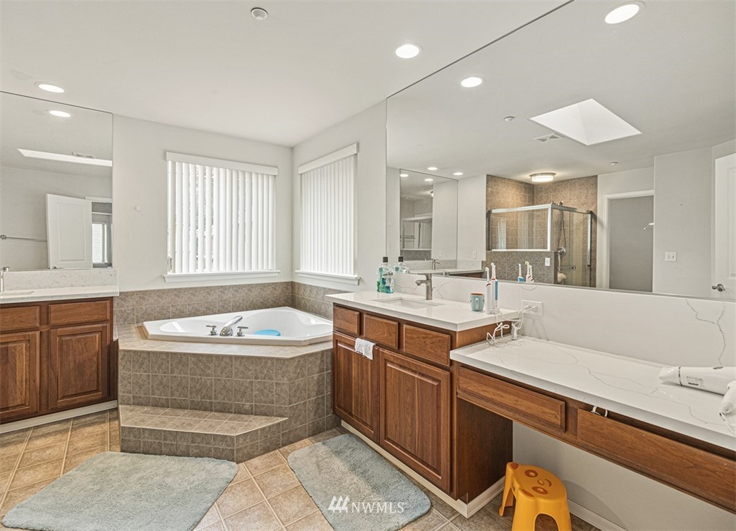 910 South 48th Street Renton, WA 98055 - Photo 24 of 30 a spacious bathroom with a sink double vanity granite tub and a mirror