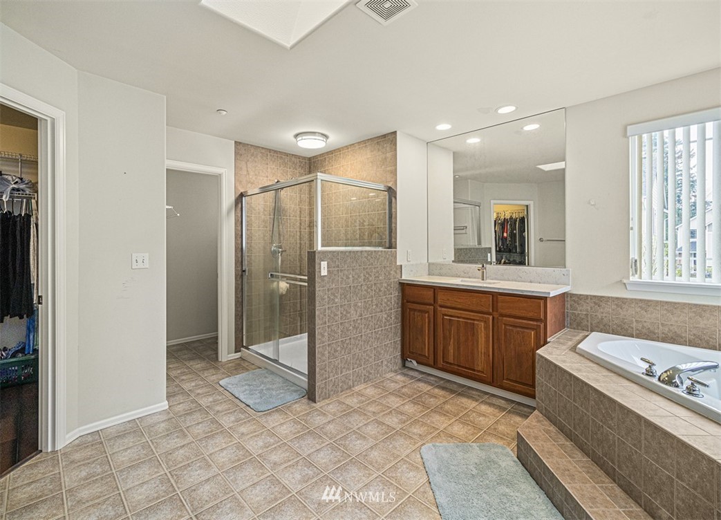 910 South 48th Street Renton, WA 98055 - Photo 25 of 30 a bathroom with a granite countertop sink mirror and shower