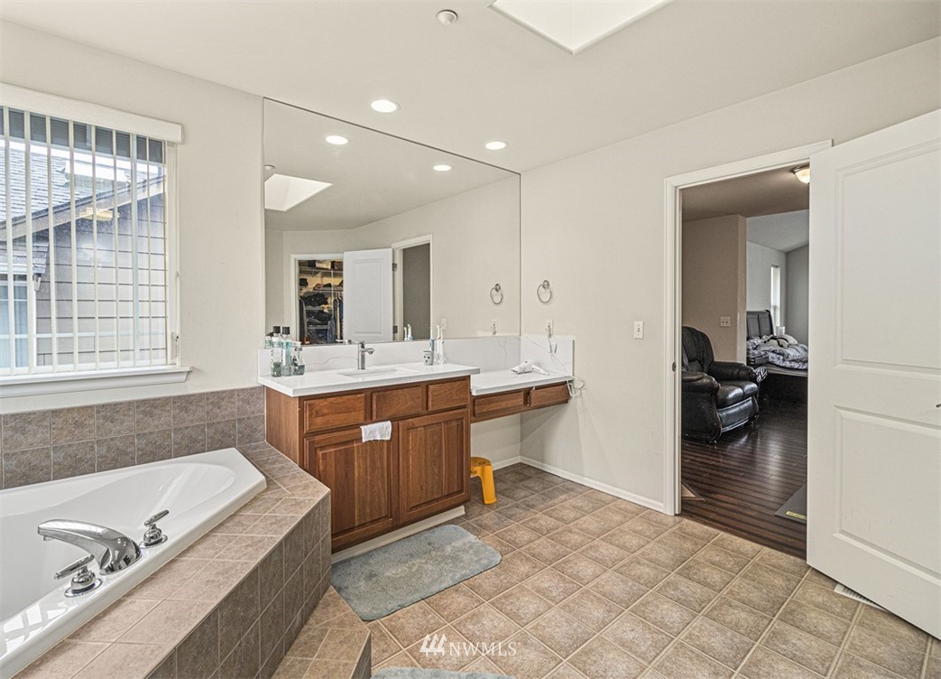 910 South 48th Street Renton, WA 98055 - Photo 26 of 30 a spacious bathroom with a tub sink and mirror