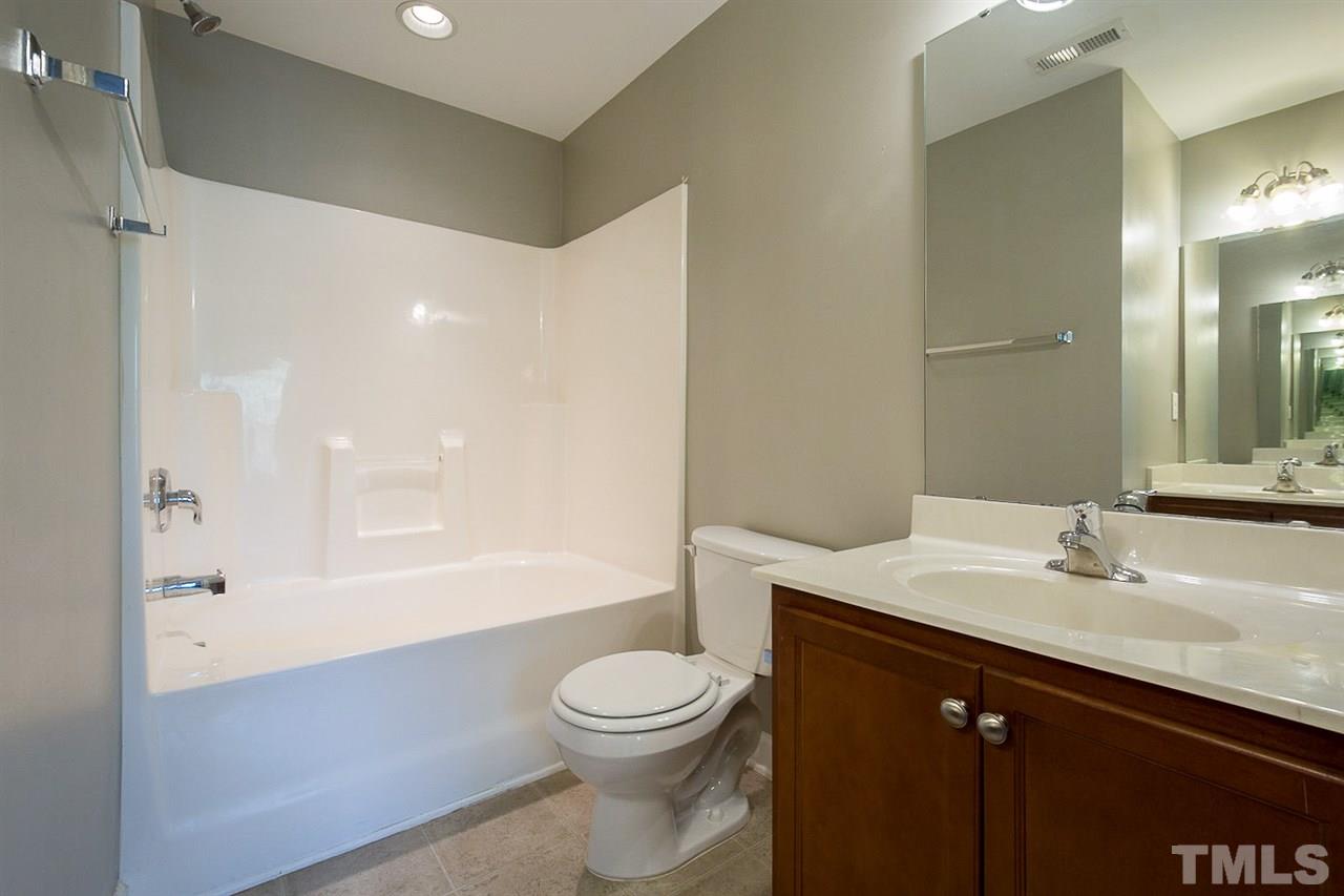 8016 Sycamore Hill Lane Raleigh, NC 27612 - Photo 11 of 19 a bathroom with a sink a toilet and shower