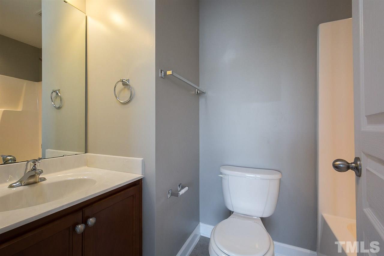 8016 Sycamore Hill Lane Raleigh, NC 27612 - Photo 14 of 19 a bathroom with a toilet sink and mirror