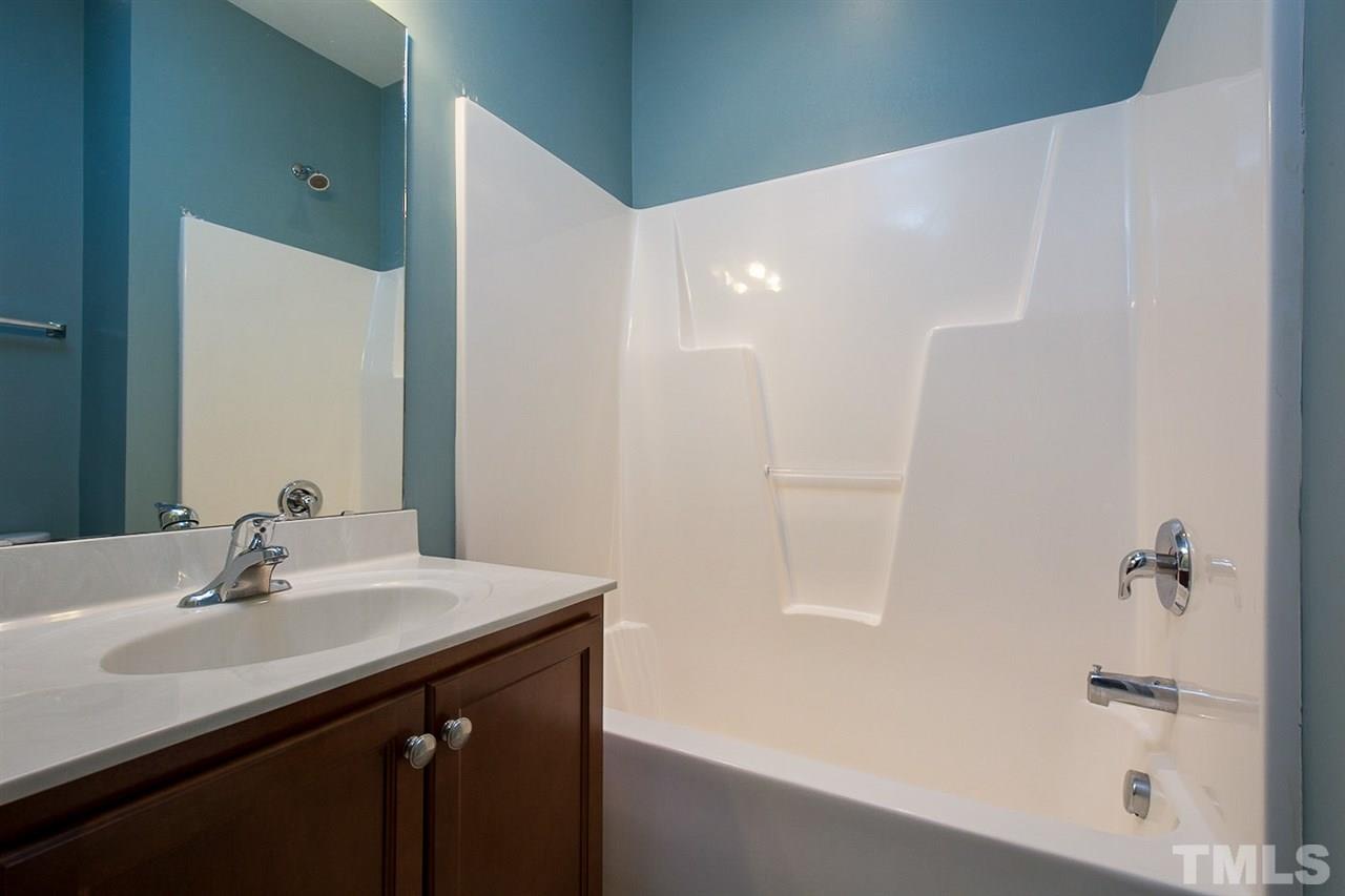 8016 Sycamore Hill Lane Raleigh, NC 27612 - Photo 17 of 19 a bathroom with a sink and a mirror