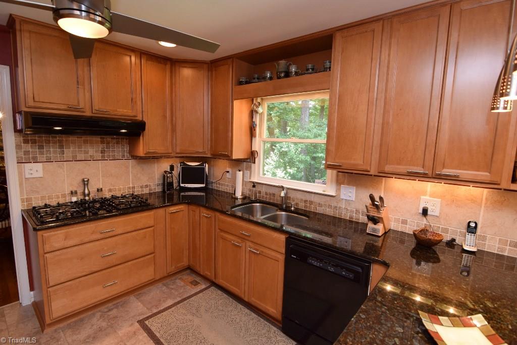 1902 Milan Road Greensboro, NC 27410 - Photo 5 of 30 Granite countertops and tile backsplash. 5 burner gas cook top.