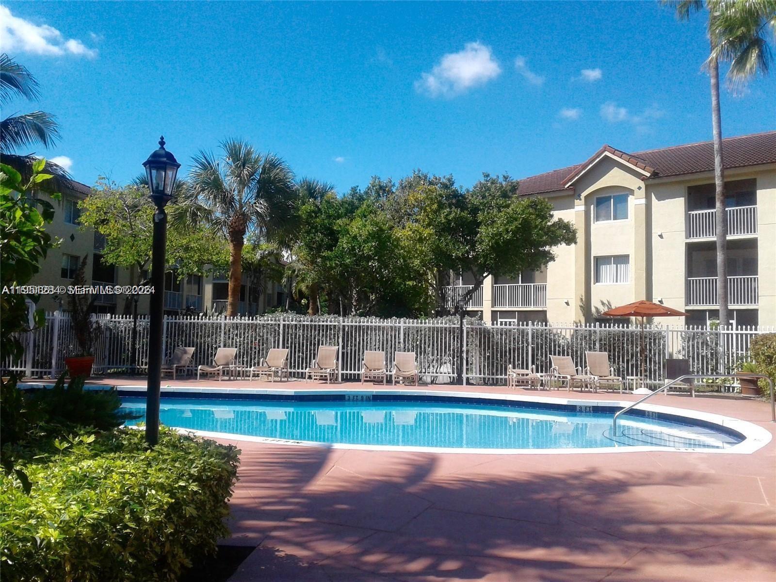 430 South Park Road, Unit 3303 Hollywood, FL 33021 - Photo 12 of 12 a view of yard with swimming pool and tall trees