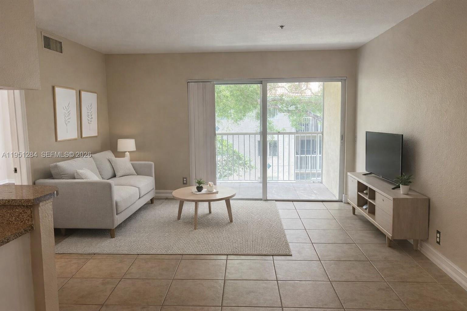 430 South Park Road, Unit 3303 Hollywood, FL 33021 - Photo 2 of 12 a living room with furniture a flat screen tv and a large window