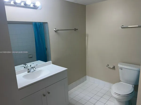 a bathroom with a sink toilet and a mirror