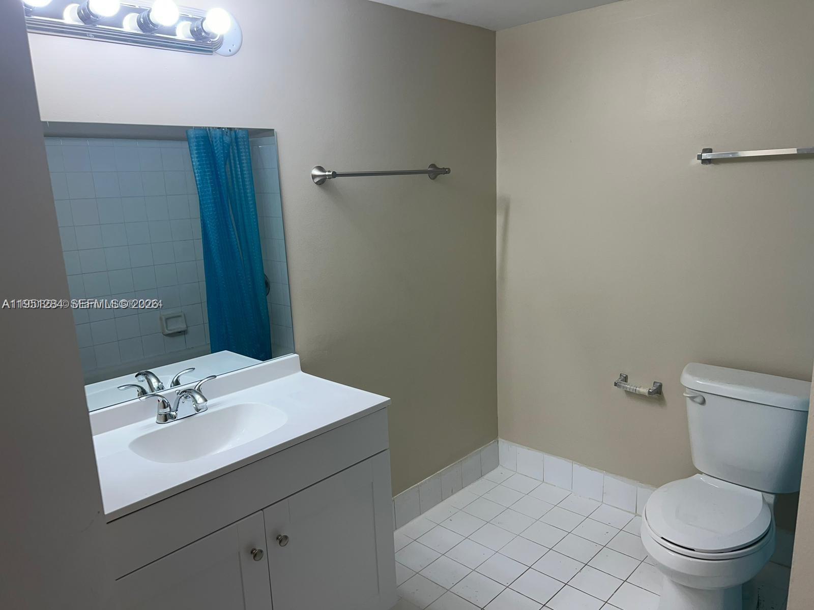 430 South Park Road, Unit 3303 Hollywood, FL 33021 - Photo 6 of 12 a bathroom with a sink toilet and a mirror