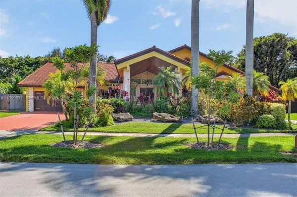 a view of a house with a yard and plants