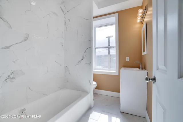 a bathroom with a bathtub and window
