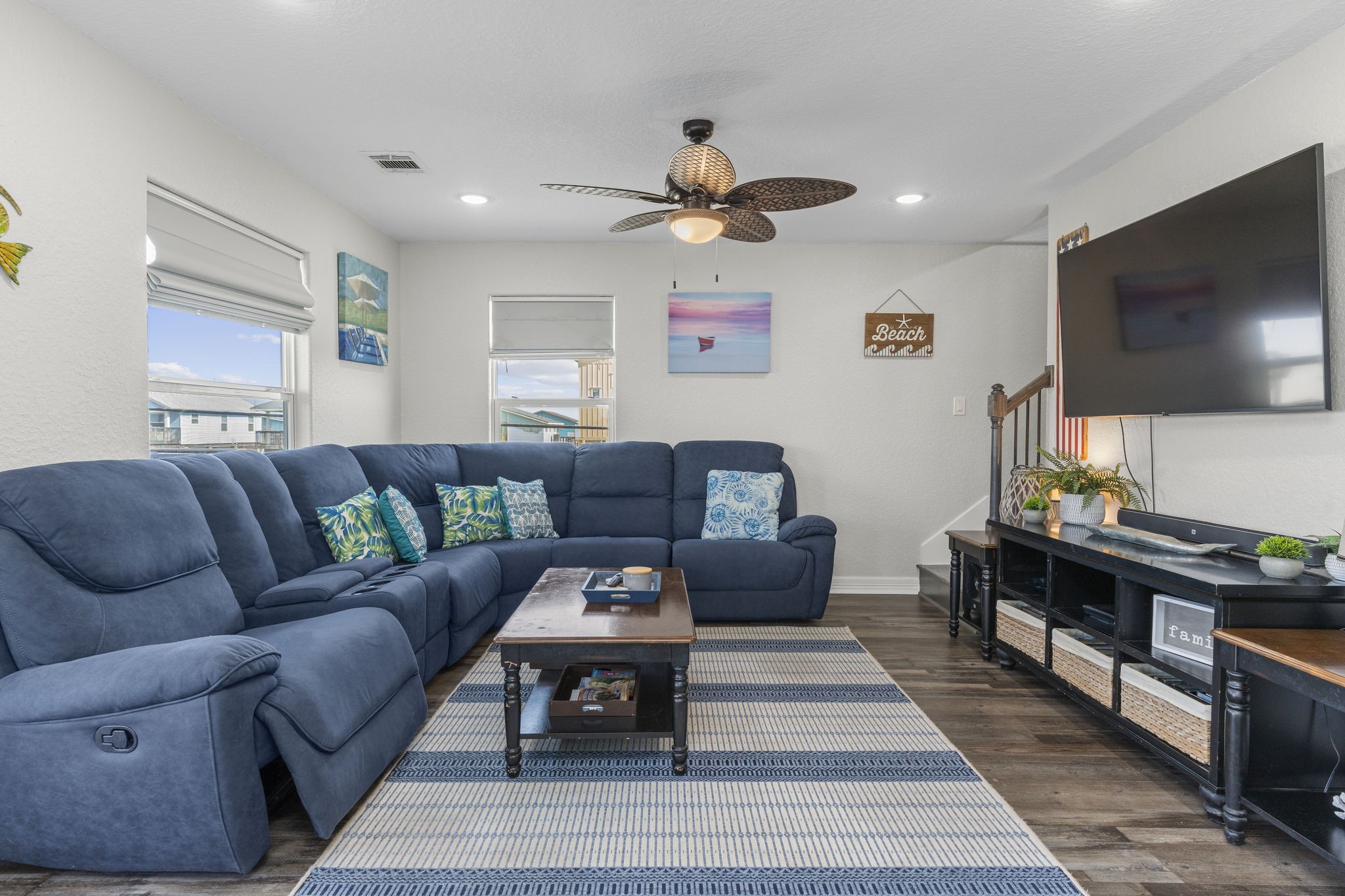 203 Sandpebble Place Surfside Beach, TX 77541 - Photo 11 of 27 a living room with furniture a flat screen tv and a rug