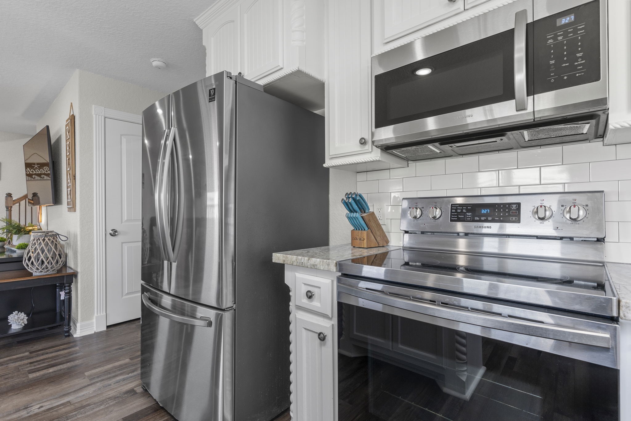 203 Sandpebble Place Surfside Beach, TX 77541 - Photo 14 of 27 a kitchen with stainless steel appliances a refrigerator and a stove top oven