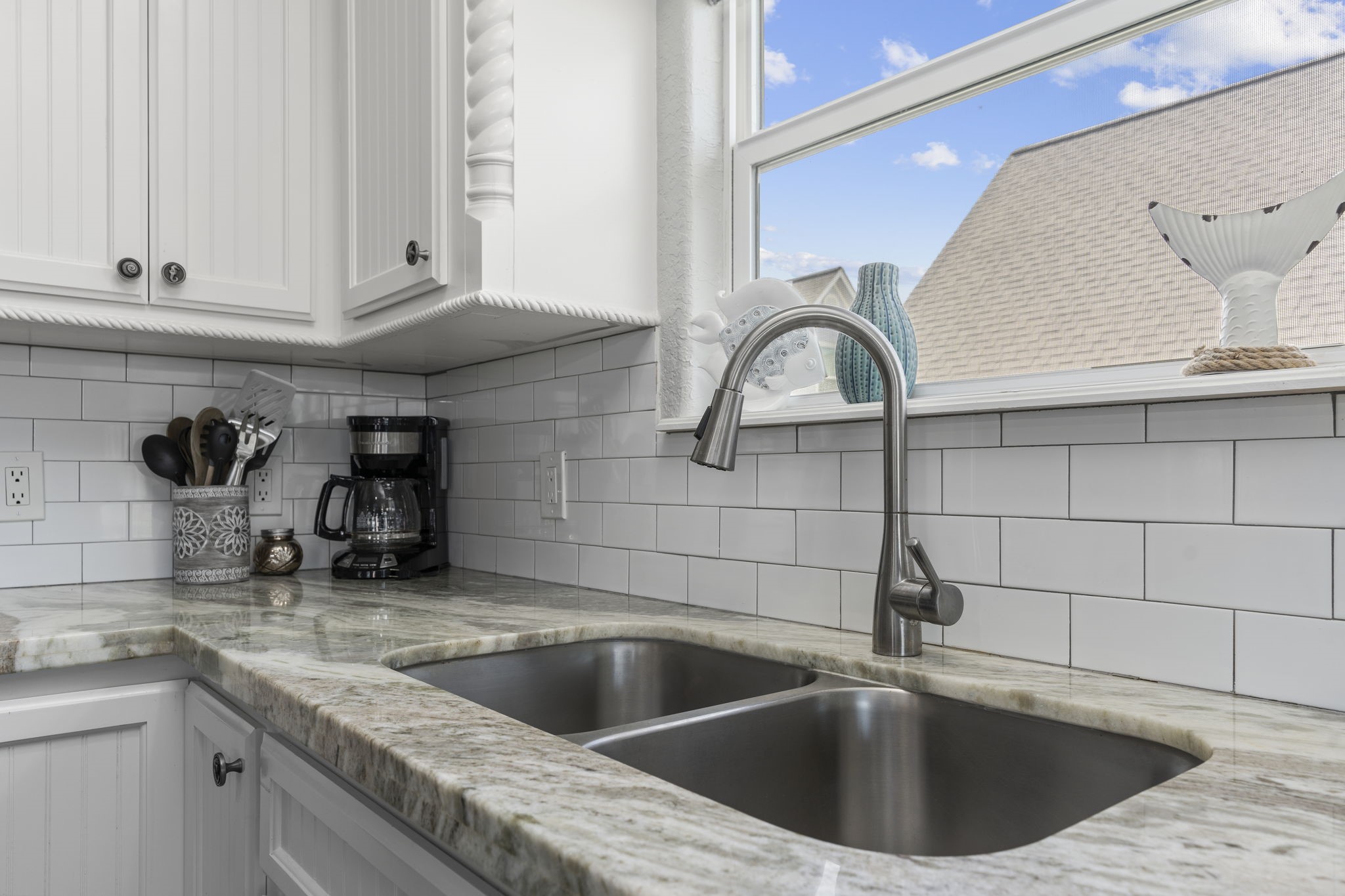 203 Sandpebble Place Surfside Beach, TX 77541 - Photo 15 of 27 a kitchen with a sink and cabinets