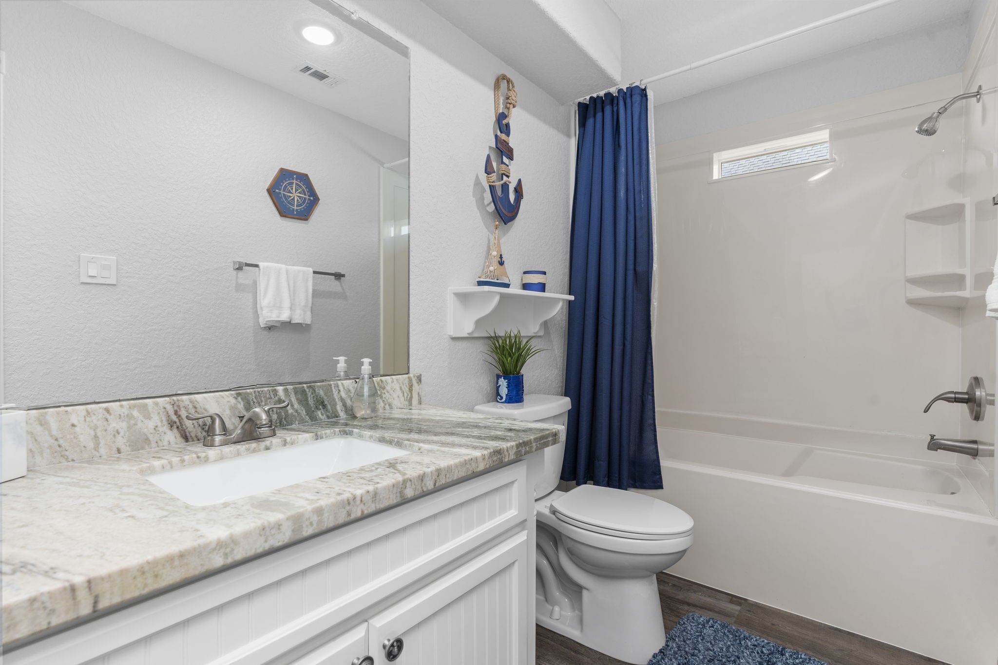 203 Sandpebble Place Surfside Beach, TX 77541 - Photo 18 of 27 a bathroom with a granite countertop sink toilet and shower