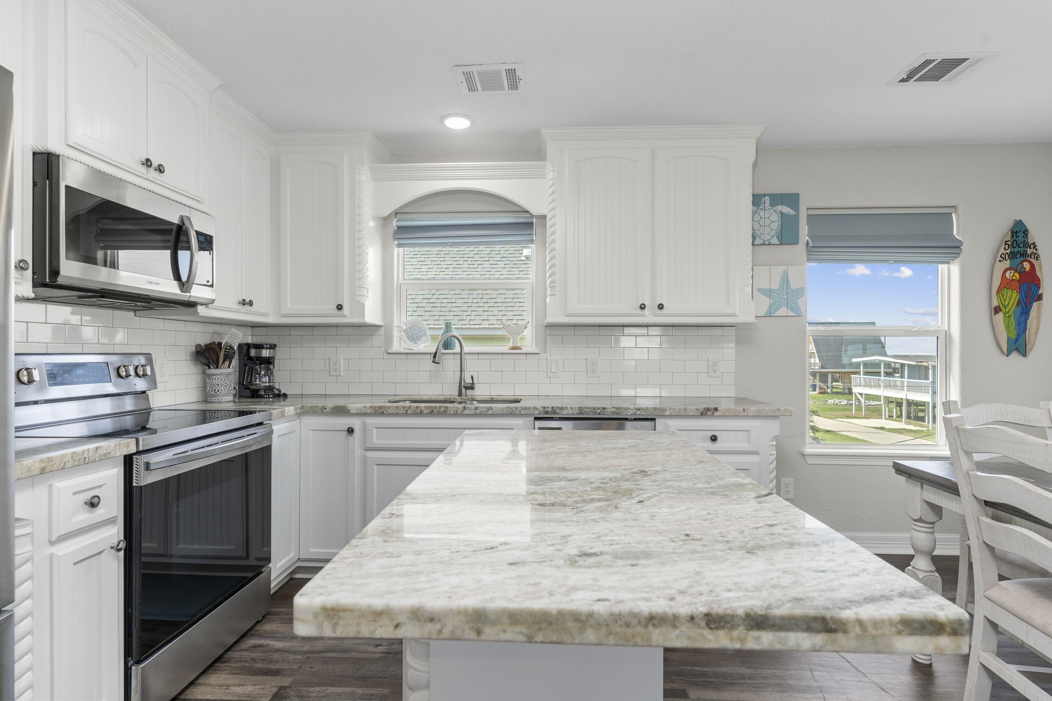 203 Sandpebble Place Surfside Beach, TX 77541 - Photo 2 of 27 a kitchen with stainless steel appliances granite countertop wooden cabinets granite counter tops and a hard wood floors