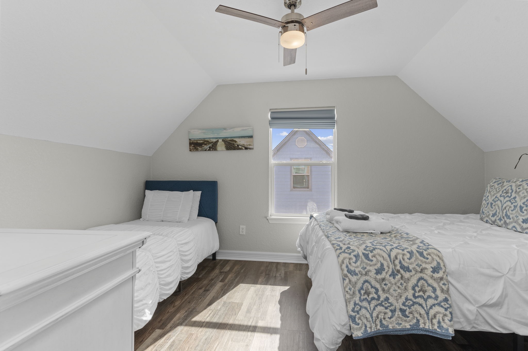 203 Sandpebble Place Surfside Beach, TX 77541 - Photo 21 of 27 a bedroom with a large bed and a chandelier