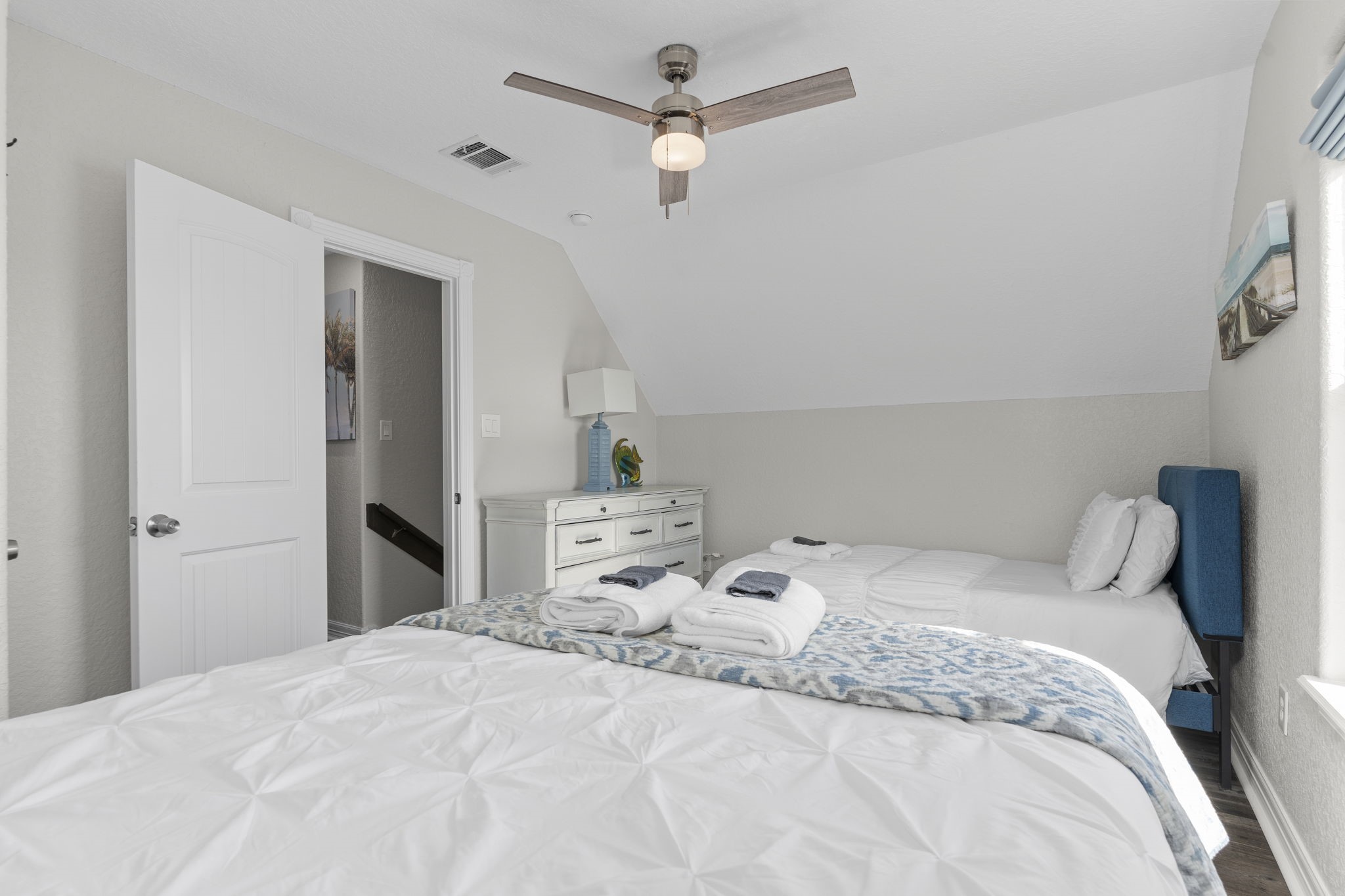 203 Sandpebble Place Surfside Beach, TX 77541 - Photo 22 of 27 a bedroom with a bed and a chandelier