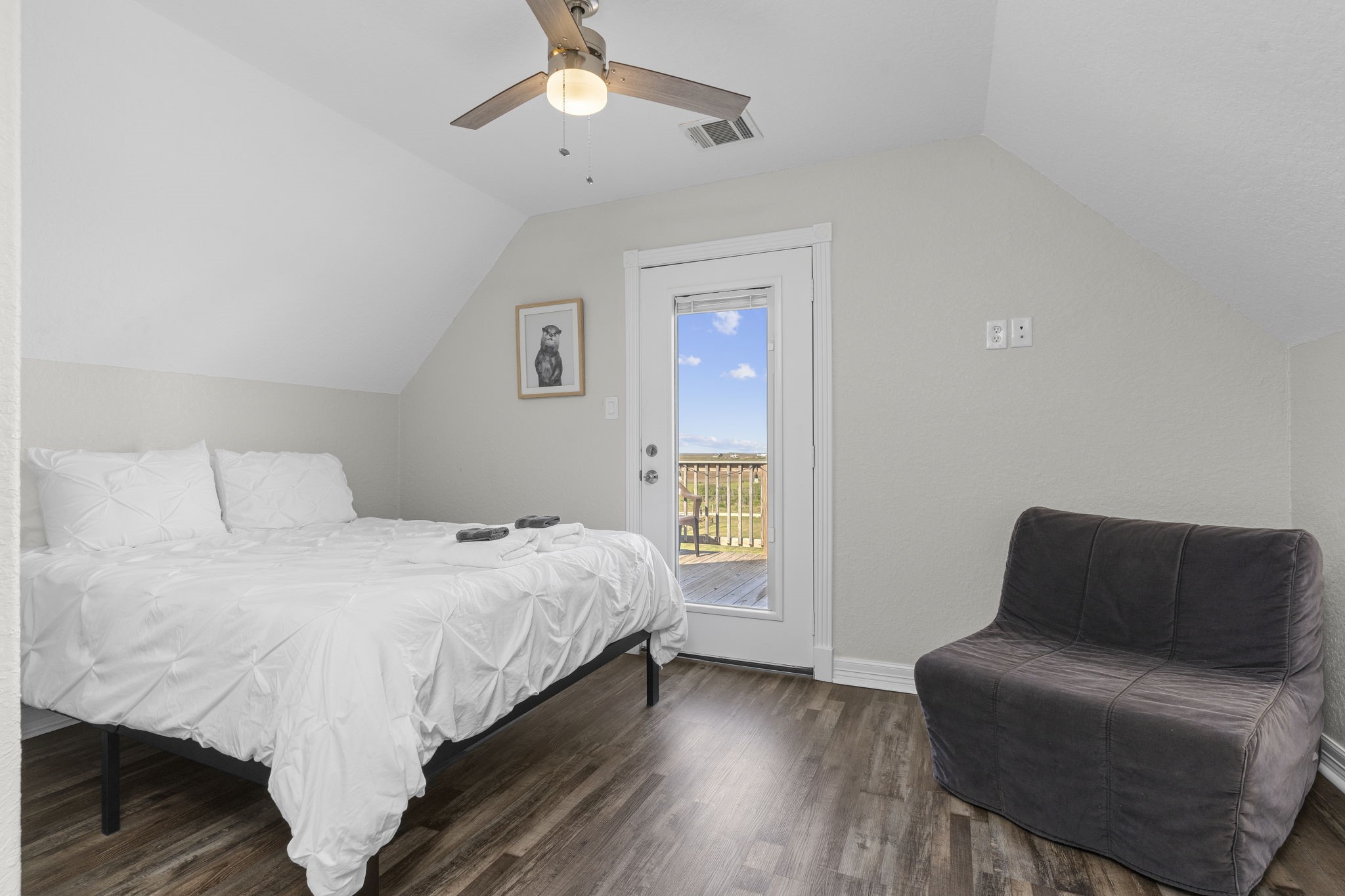 203 Sandpebble Place Surfside Beach, TX 77541 - Photo 24 of 27 a bedroom with a bed couch and a window