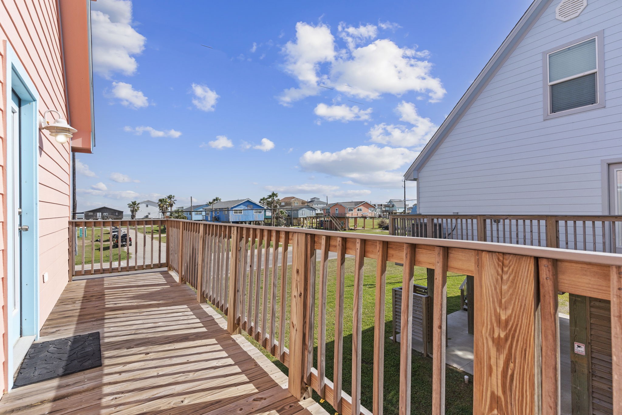 203 Sandpebble Place Surfside Beach, TX 77541 - Photo 26 of 27 a balcony with wooden floor and city view