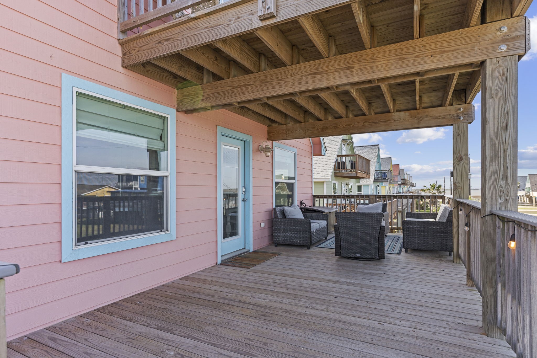 203 Sandpebble Place Surfside Beach, TX 77541 - Photo 9 of 27 a view of a terrace with furniture and wooden floor