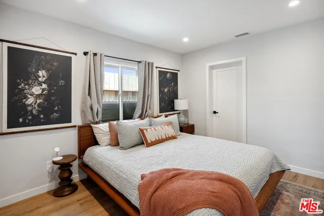 a bedroom with a large bed and a window