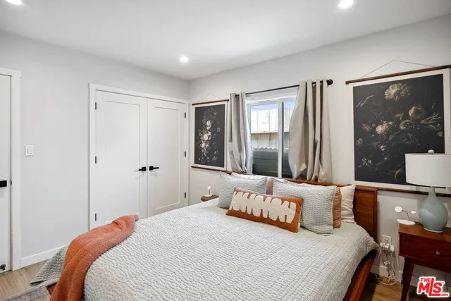 a bedroom with a large bed and a large mirror