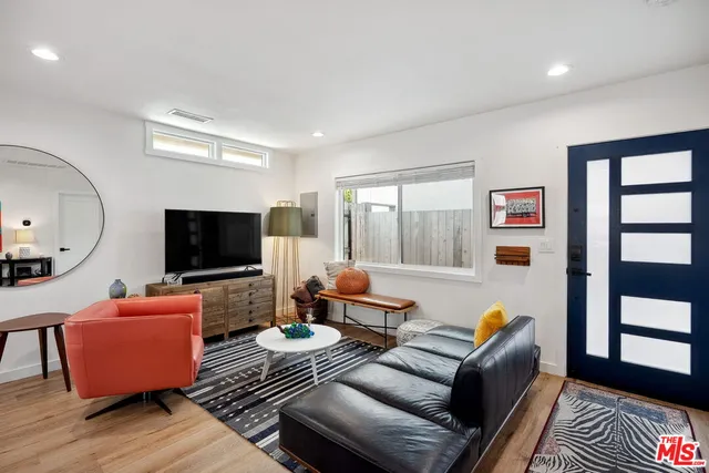 a living room with furniture chess table and a large window