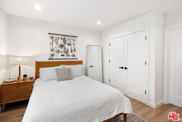 a bedroom with a bed and a desk