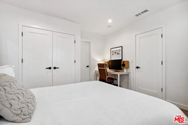 a bedroom with a bed and a television