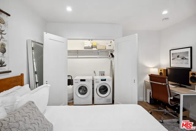 a bedroom with a large bed and a window