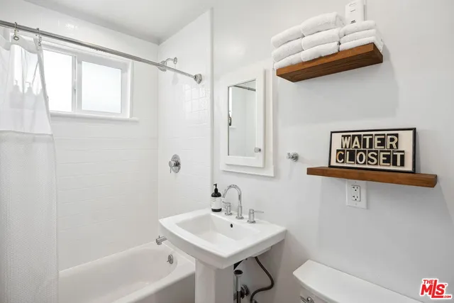 a view of a house with backyard sitting area and swimming pool