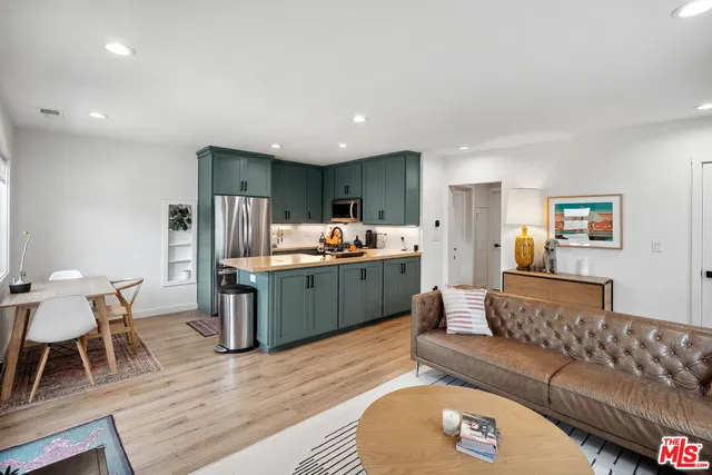 a living room with furniture and kitchen view