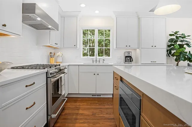 a kitchen with a sink stove and cabinets