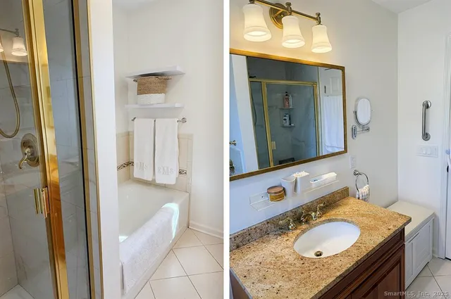 a bathroom with a granite countertop sink vanity and mirror