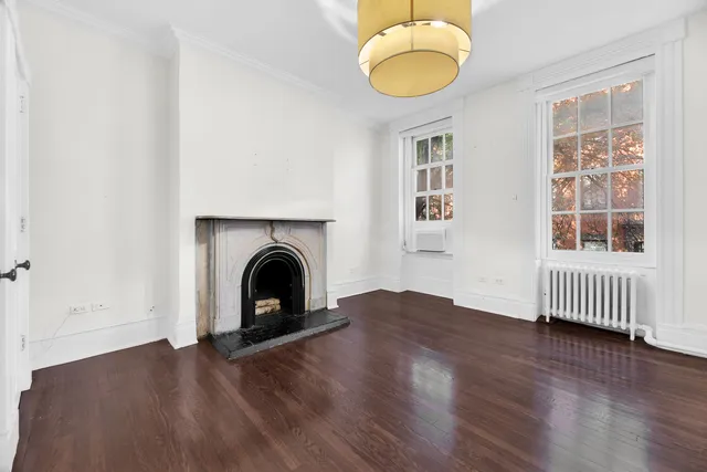 a wooden bench sitting in front of a building