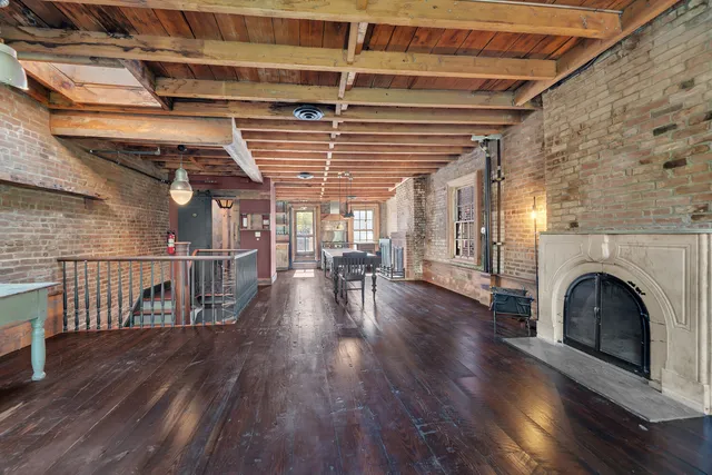 a view of a livingroom with wooden floor and a window